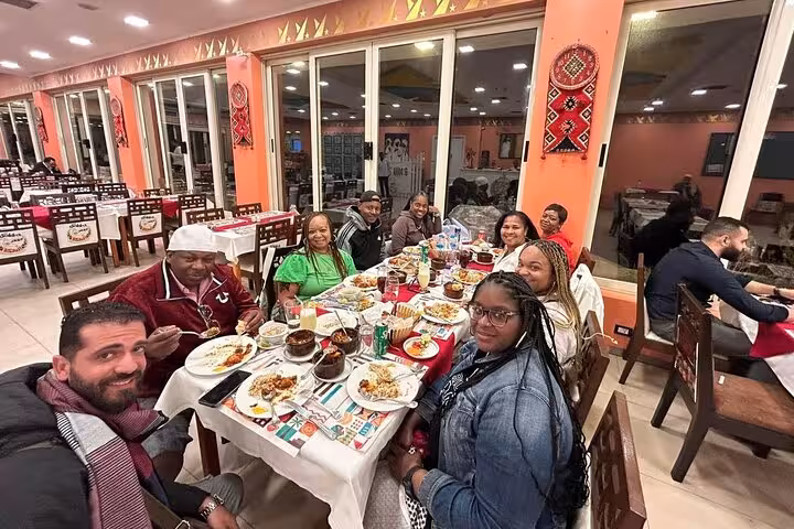 Travelers share a traditional Egyptian dinner spread on an Eat Like a Local food and tea tour in Cairo
