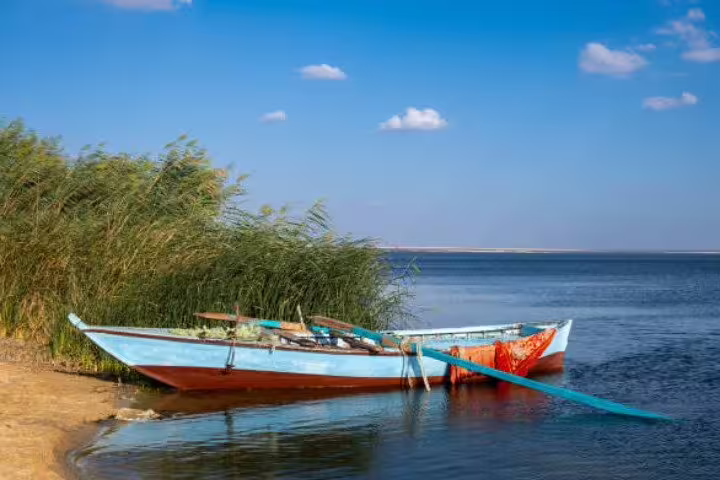 Traditional fishing boat on Lake Qarun shoreline in El Fayoum Oasis, Egypt, visited on an overnight camping tour from Cairo
