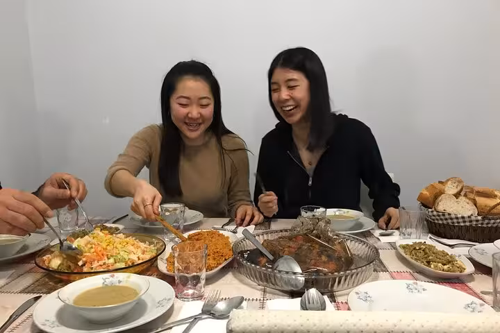 Guests enjoy a traditional Istanbul family dinner with homemade Turkish meze, rice and shared laughter at the table