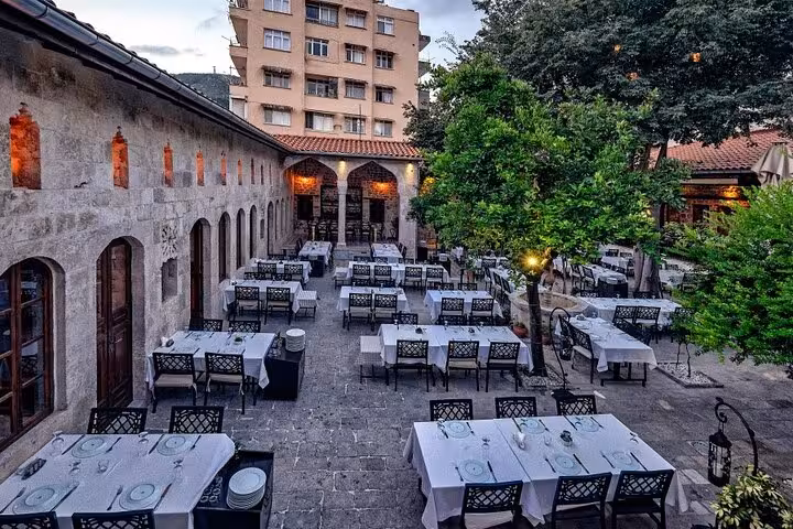 Traditional Turkish courtyard restaurant set for dinner, ideal stop on a Turkish cuisine gastronomy tour