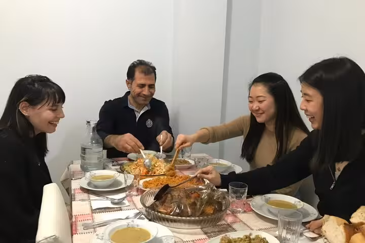 Guests share homemade Turkish dishes at a traditional family dinner in Istanbul with a local host family