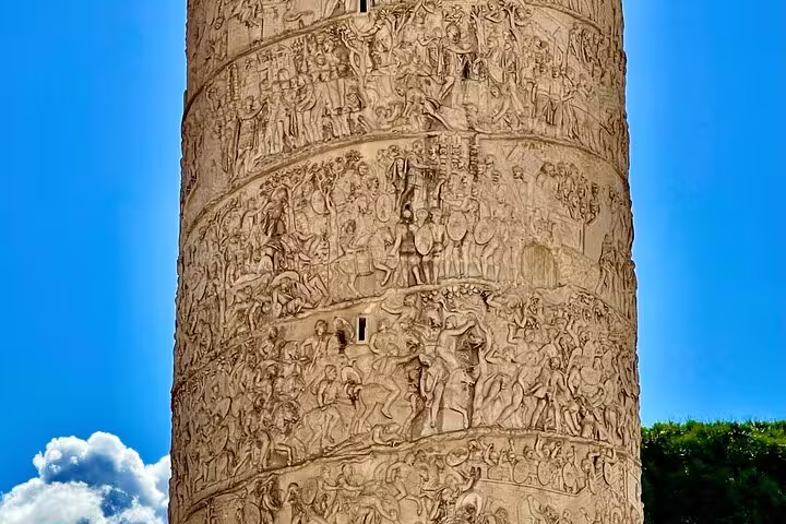 Close-up of Trajan’s Column reliefs against a bright blue sky on a Rome Colosseum, Forum and panoramic city views tour