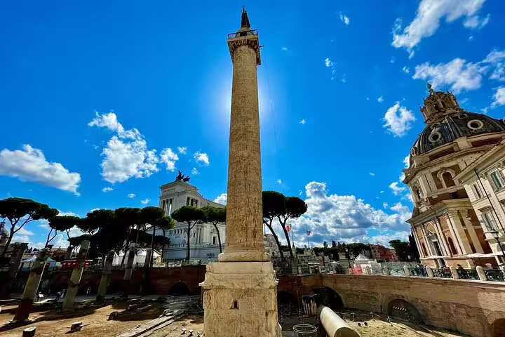 Panoramic view of Trajan’s Column and Rome skyline near the Roman Forum on a sunny Colosseum and Palatine Hill tour