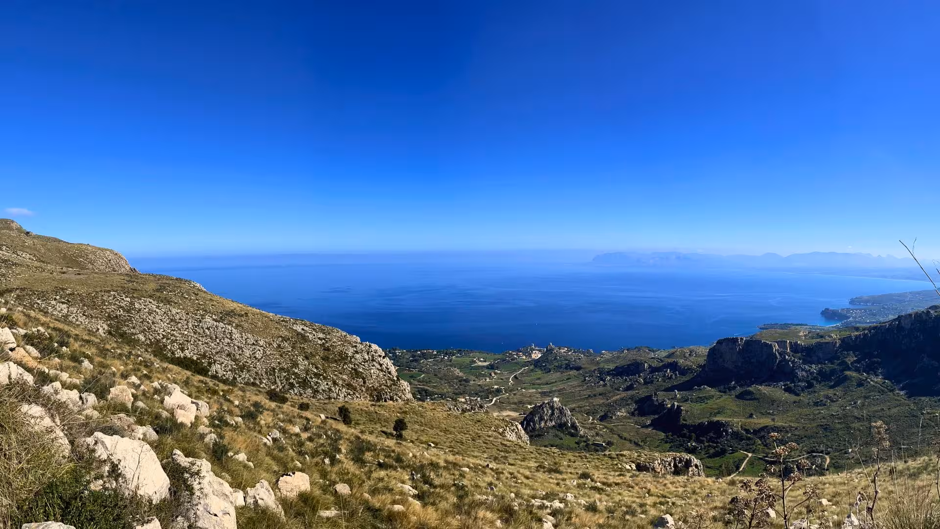 Stunning coastal vista from Erice, showcasing rugged terrain and sparkling sea, perfect for ebike exploration.