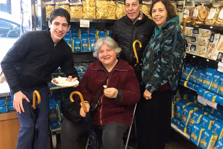 Group enjoying pasta and local specialties in a Trastevere shop during a food tour.