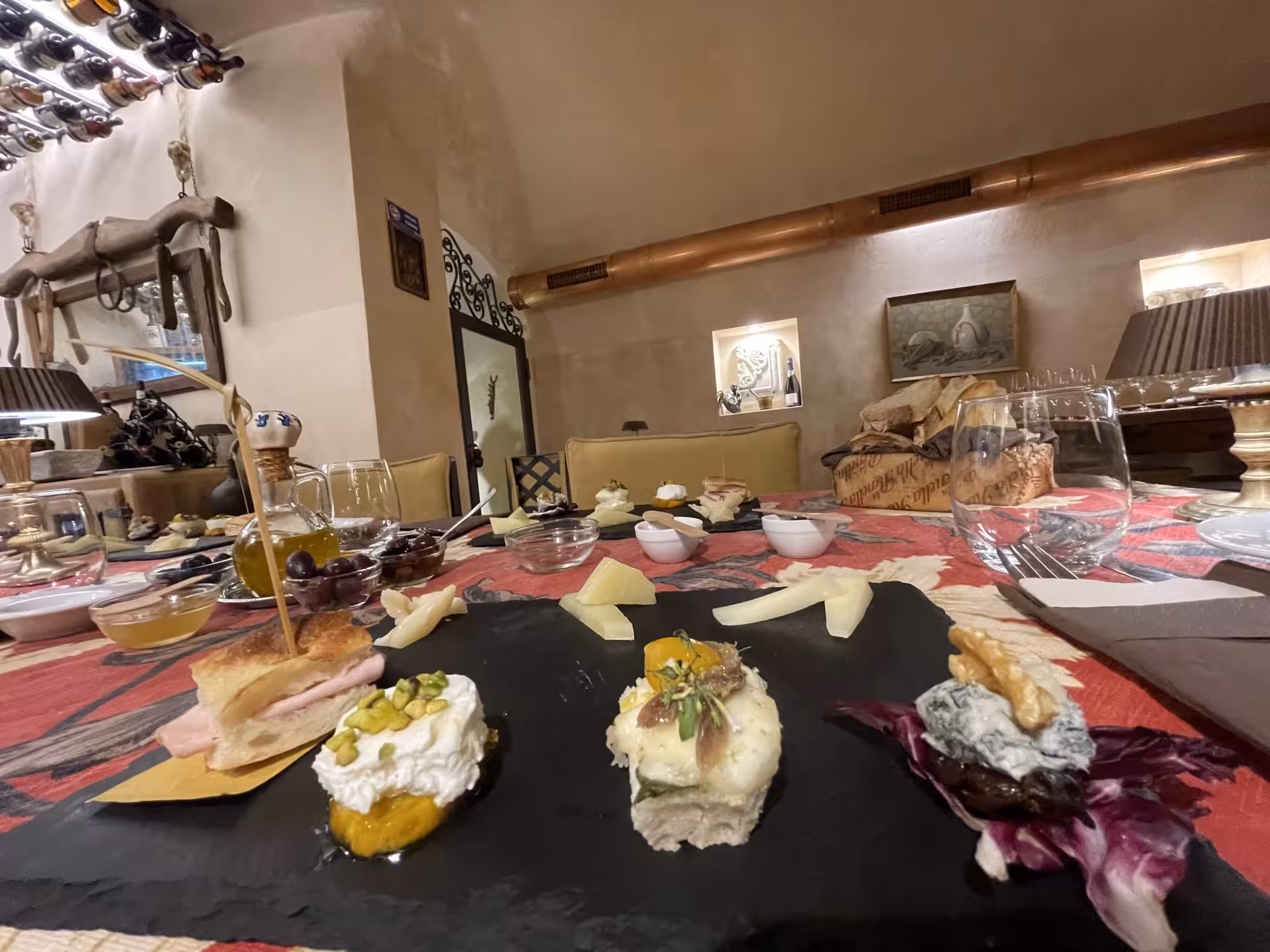 Gourmet Italian appetizers with cheese and bread on a slate platter during Trastevere Food & Wine Tour.