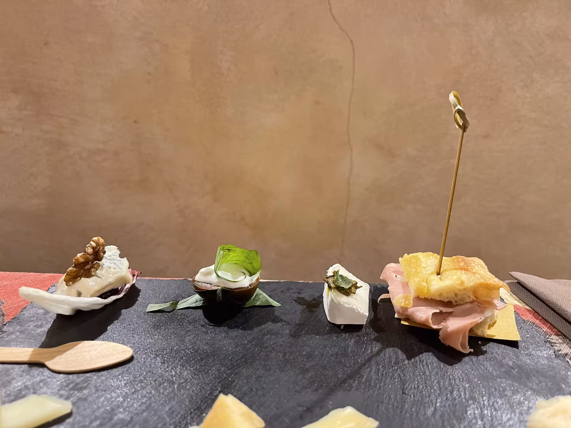 Close-up of Italian charcuterie and cheese sampler on a slate in Trastevere's culinary tour.