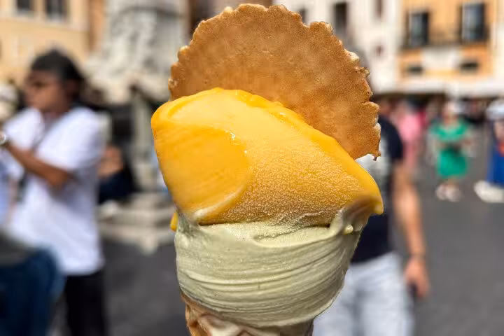 Savor creamy gelato with a wafer in Trastevere, a highlight of our Rome food and wine tour.