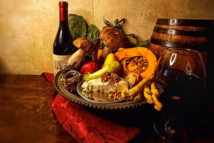 Rustic Trastevere wine and food still life with red wine bottle, glass, porcini mushrooms, pumpkin and Italian cheese in Rome