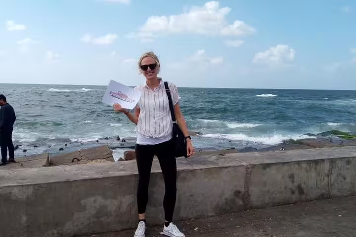 Traveler on Alexandria Corniche by the Mediterranean Sea, a stop on private day tour from Cairo to Alexandria