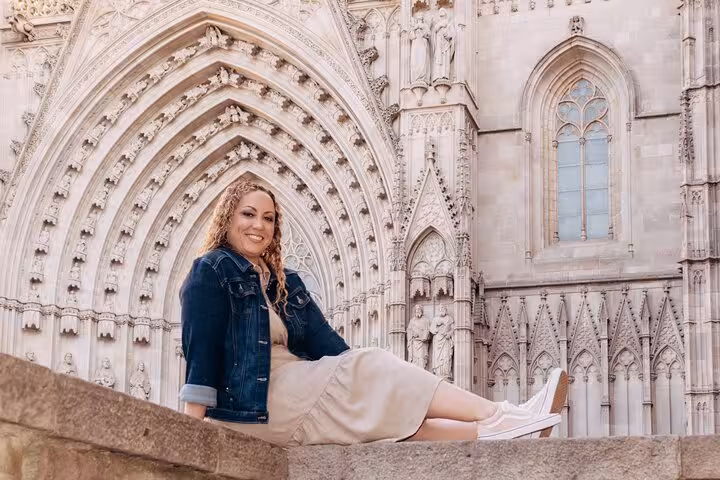 Smiling traveler by Barcelona Cathedral’s ornate Gothic arch, Timeless Barcelona personal photoshoot in the Gothic Quarter.