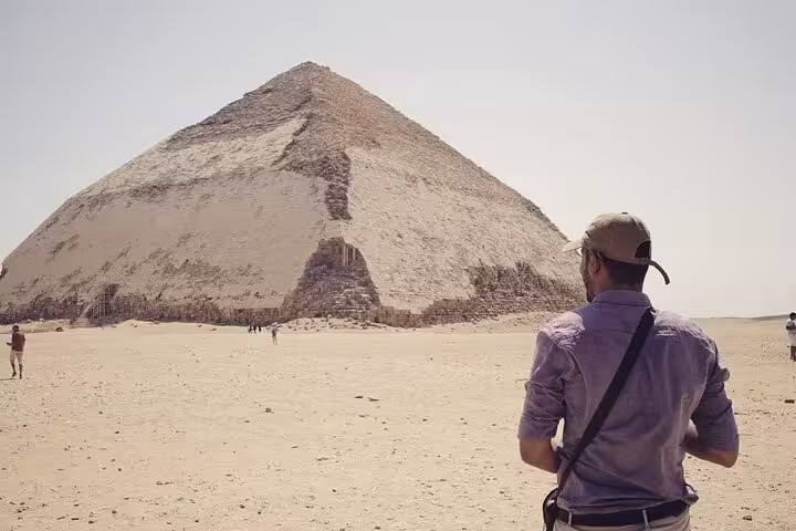 Traveler facing the Bent Pyramid at Dahshur on Saqqara Pyramids and Memphis day tour with lunch from Cairo