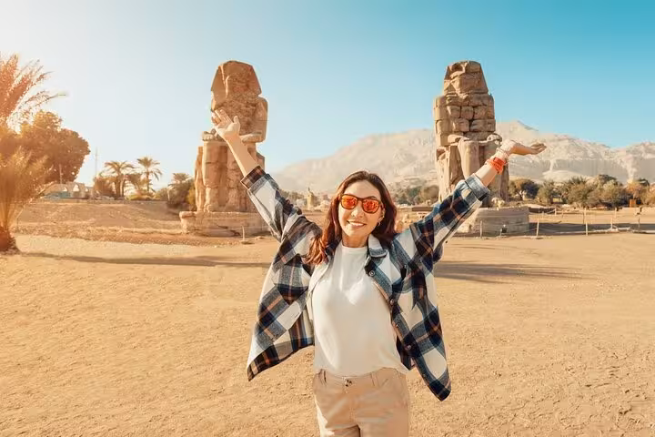 Happy traveler by Colossi of Memnon, Luxor on 2-day private tour from Hurghada with Abu Simbel