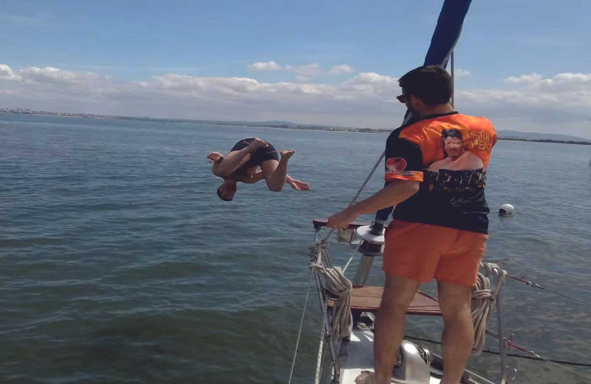 Traveler flips into the ocean from a sailboat on the Fun & Swim tour, sea swim adventure