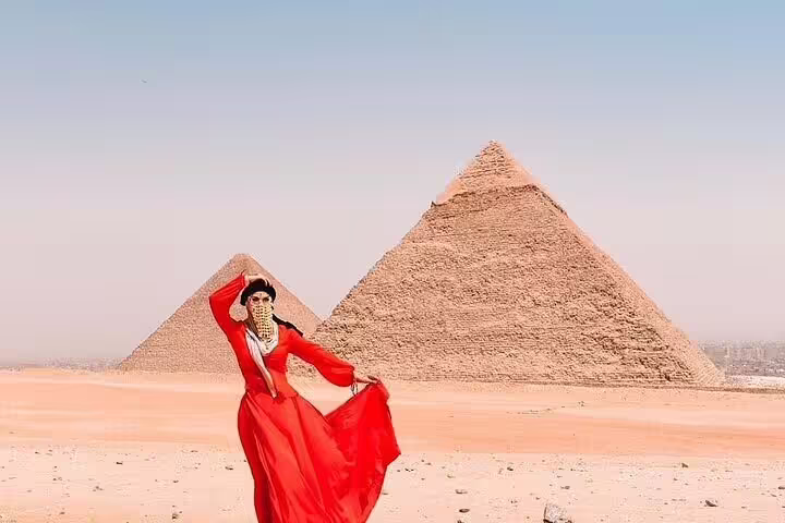 Traveler posing in red dress at Giza Pyramids on 2-day Cairo and Alexandria tour from Port Said cruise port