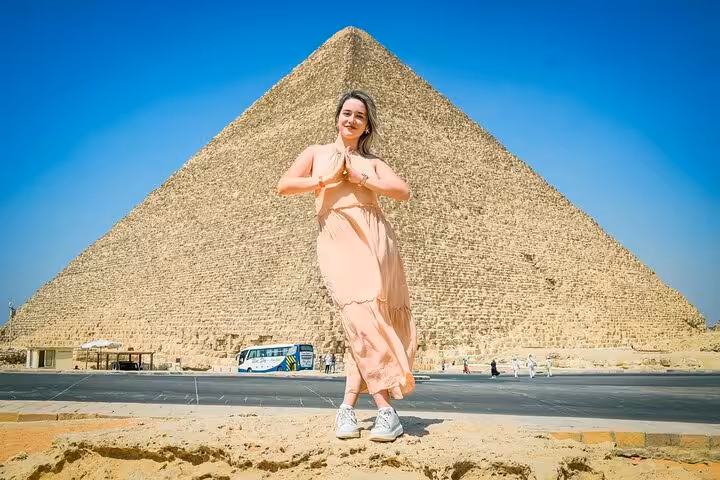 Traveler posing at the Great Pyramid of Giza on a Cairo day trip tour with lunch, Egypt sightseeing