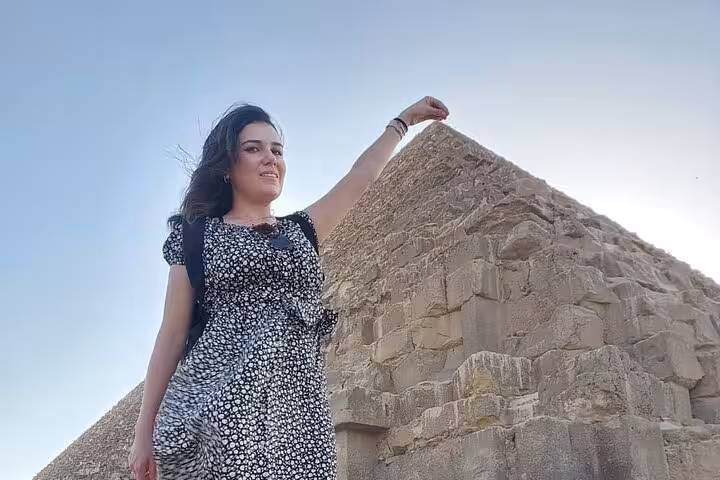 Traveler posing by the Great Pyramid of Giza on a 3-day Cairo itinerary with pyramids, churches and museums