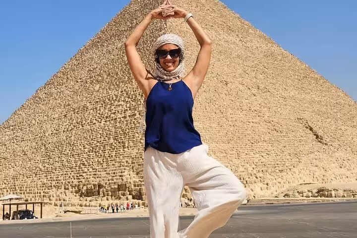 Traveler posing in front of the Great Pyramid of Giza on a full-day Cairo tour with hotel pickup