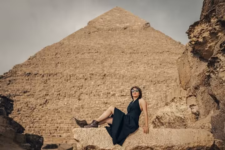 Traveler posing by the Great Pyramid of Giza on a private tour, iconic Egypt pyramids experience in Cairo