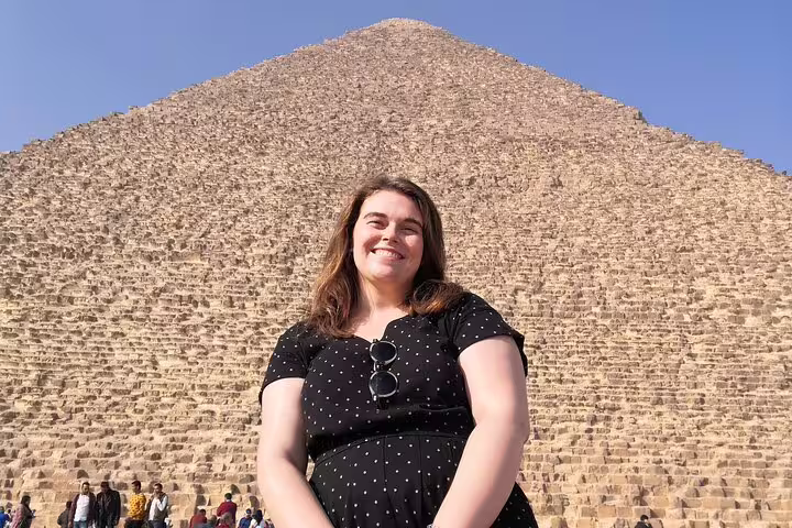Smiling traveler in front of the Great Pyramid of Giza on a private 3-day Cairo, Giza and Alexandria tour