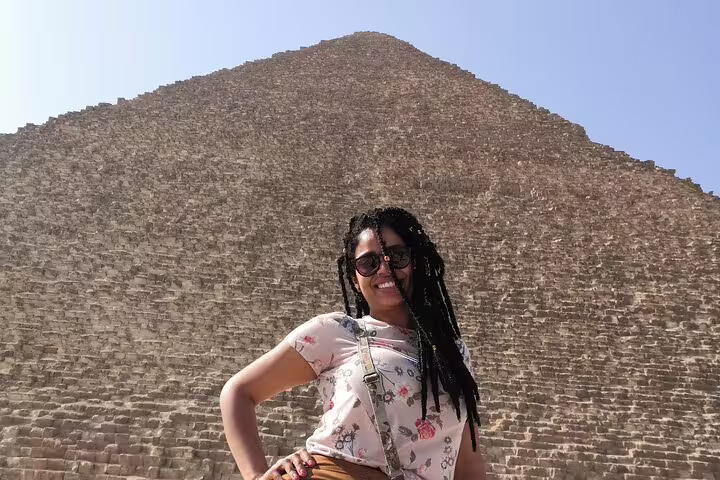 Traveler posing by the Great Pyramid of Giza on a private customized 3-day Cairo, Giza and Alexandria tour