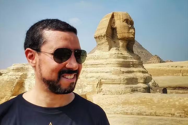 Traveler by the Great Sphinx of Giza on Cairo day trip tour to pyramids, citadel and Old Coptic Cairo