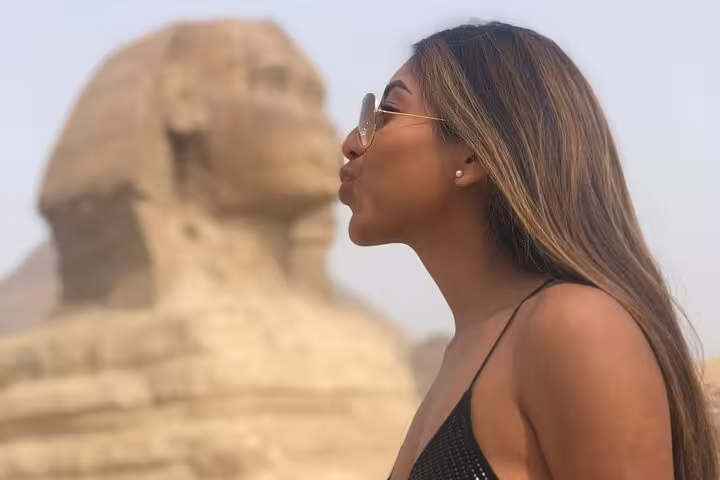 Traveler posing by the Great Sphinx at Giza, a highlight of the private Cairo pyramids and Nile felucca tour