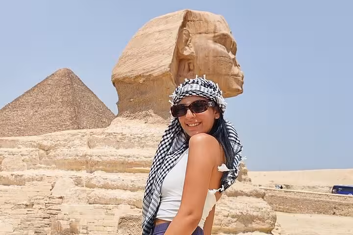 Smiling traveler by the Great Sphinx and Giza Pyramid on Grand Egyptian Museum and Giza Pyramids tour