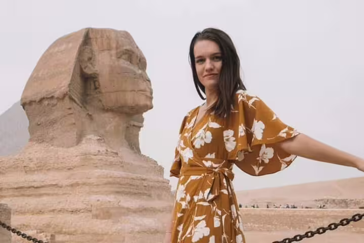 Traveler posing by the Great Sphinx on private Alexandria Port to Giza Pyramids tour, Cairo day excursion