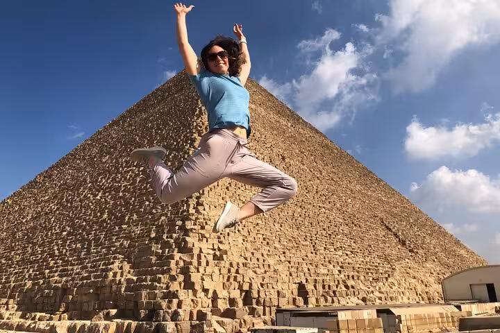 Traveler jumping in front of the Great Pyramid on a private Giza tour with lunch and camel ride option