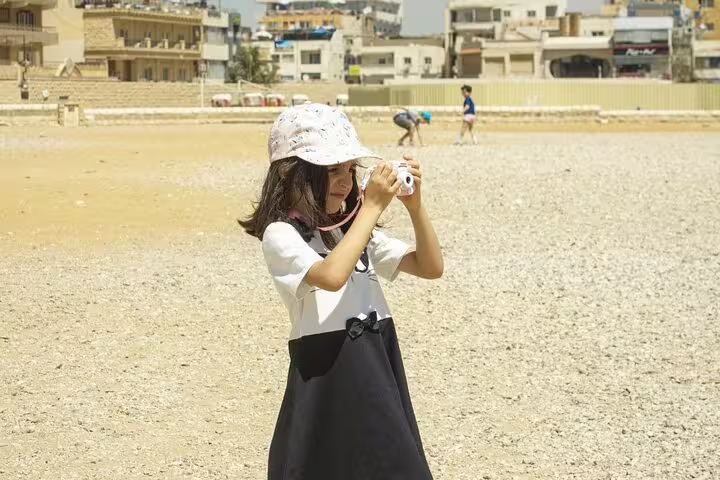Traveler taking photos on a sandy Cairo shore, a fun stop on a 3-day Cairo highlights tour