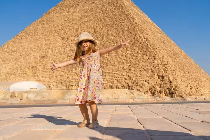 Traveler posing for epic photos by the Great Pyramid on a skip-the-line hidden gems Giza tour
