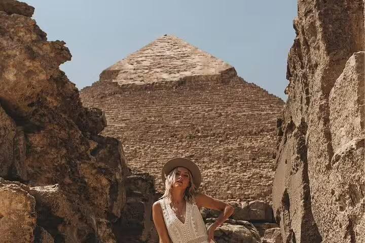 Traveler in Sakkara beside ancient ruins with the Step Pyramid of Djoser on a Cairo luxury day tour