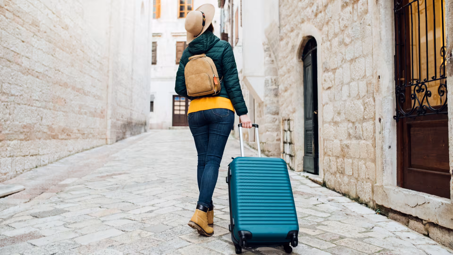 Traveler pulling suitcase, ideal for London luggage storage near Paddington Station for hands-free sightseeing