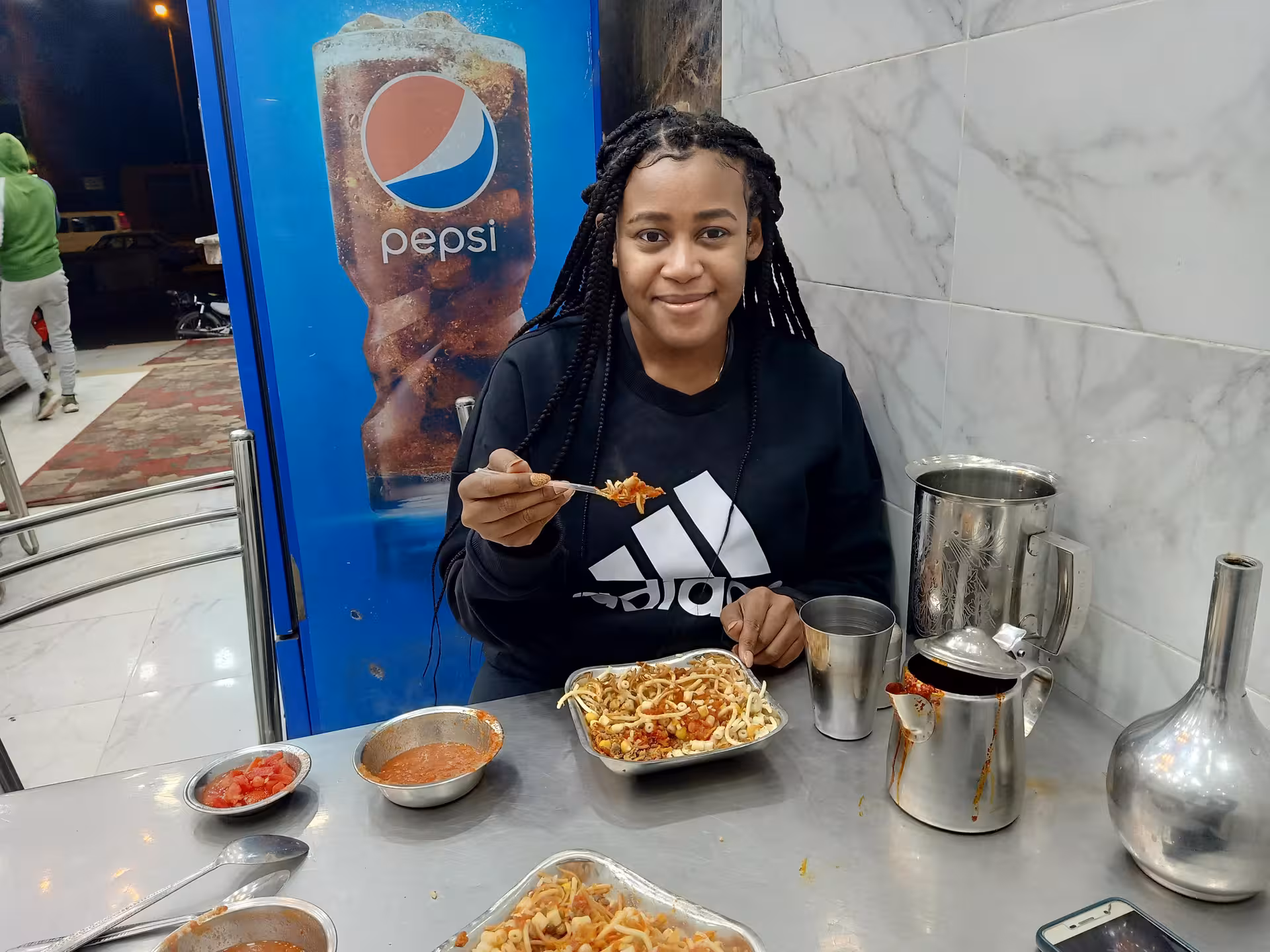 Traveler tasting koshari at a local Cairo eatery on a private food tour and funny walking experience