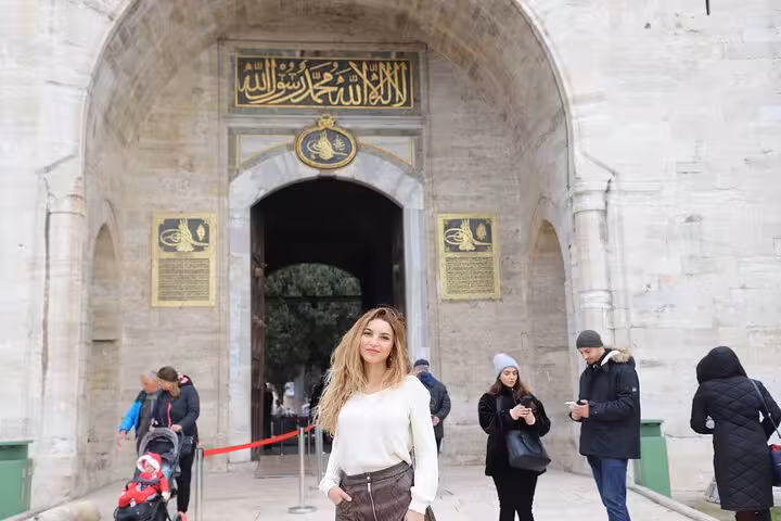Traveler at Topkapi Palace main gate in Istanbul, a highlight of the half-day history and culture tour