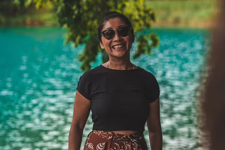 Smiling traveler by turquoise waters at Plitvice Lakes National Park during a private Croatia day tour