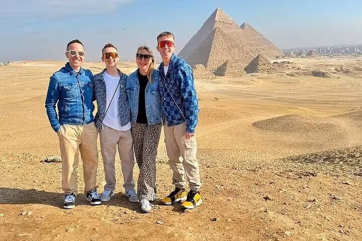 Travelers pose at Giza Pyramids on a private Cairo tour with an expert female Egyptologist guide