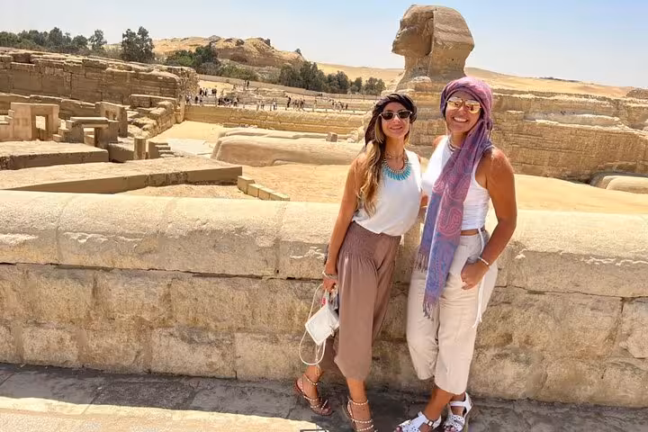 Travelers posing by the Great Sphinx at Giza, highlight of a private 2-day Cairo and Giza sightseeing itinerary