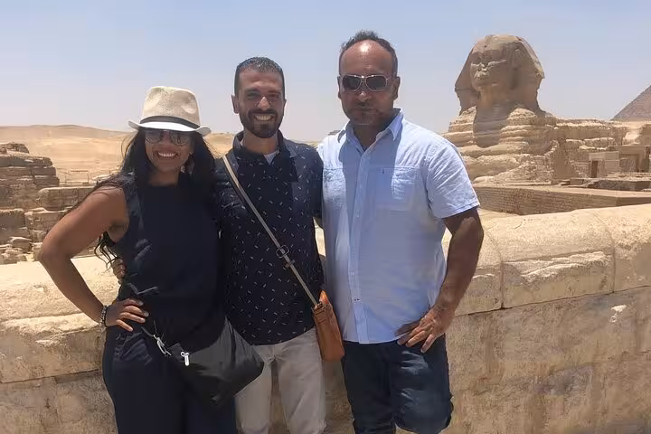 Travelers posing by the Great Sphinx of Giza on a private Giza Pyramids tour from Cairo with guide