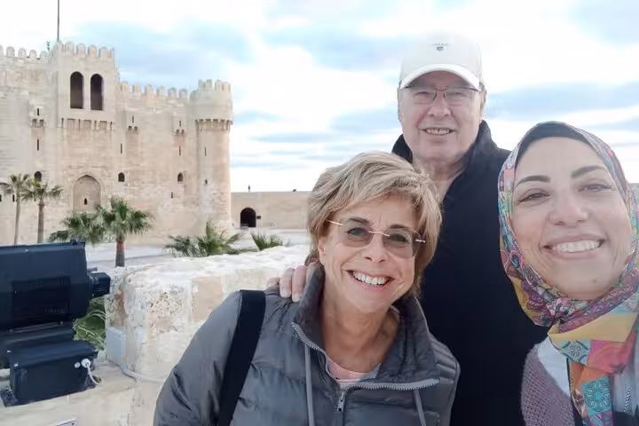 Travelers with local guide at Qaitbay Citadel, private historical Alexandria day tour from Cairo