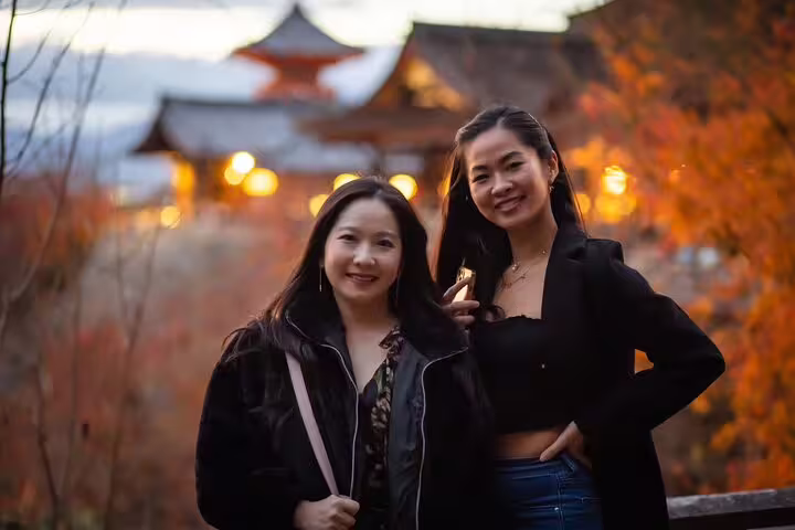 Two travelers posing at Kiyomizu-dera at sunset in autumn, Kyoto, with private vacation photographer session