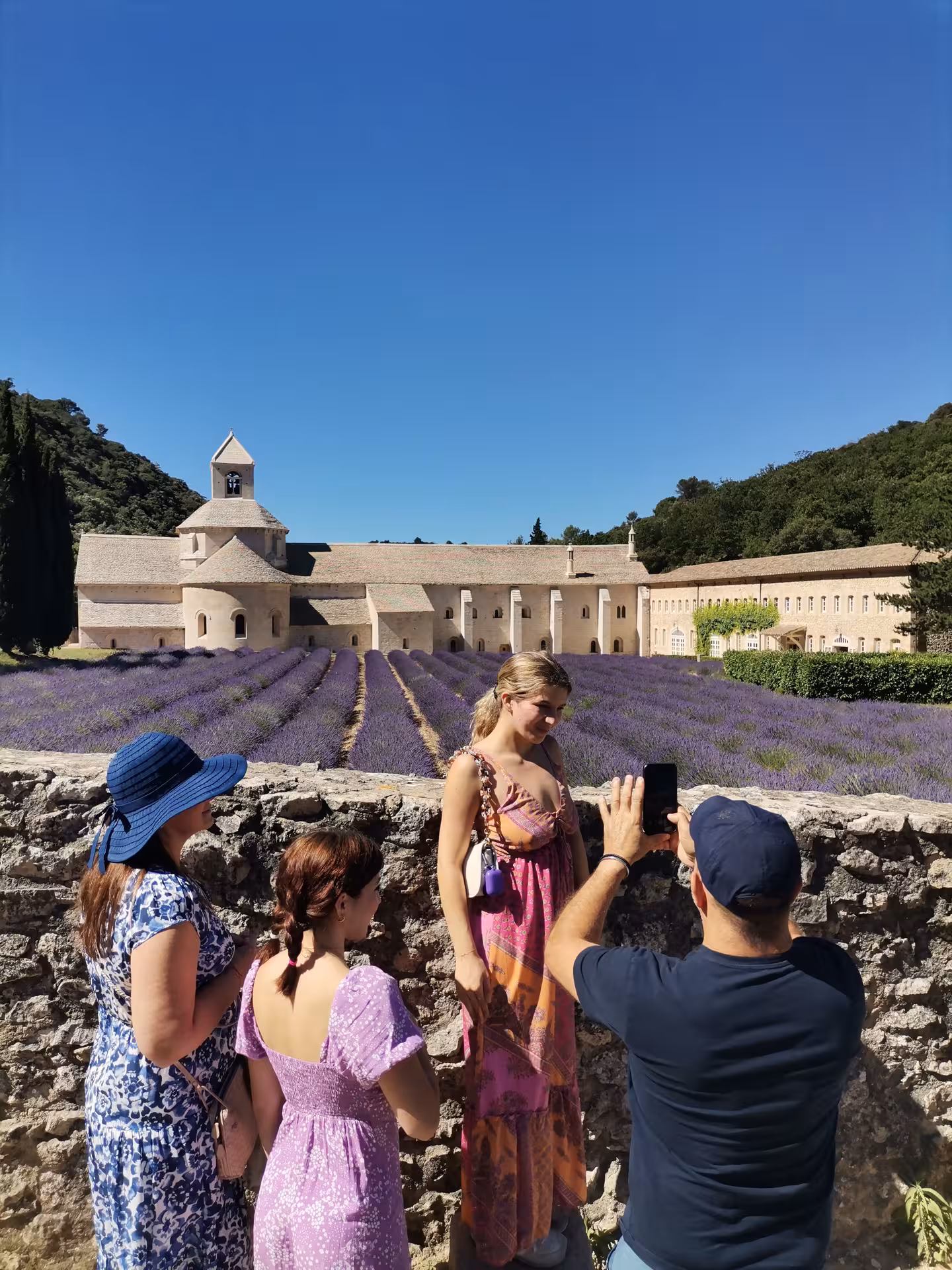 Travelers posing by lavender fields at Sénanque Abbey on a Provençal Picnic Tour in the Luberon