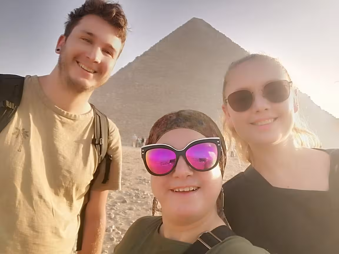 Travelers selfie at Great Pyramid of Giza, Cairo, on guided camel ride and lunch tour in Egypt