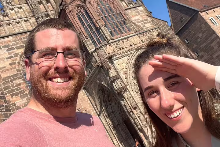 Smiling travelers selfie at St. Lorenz Church on Nuremberg self-guided scavenger hunt walking tour