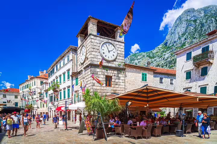 Old town square with clock tower and cafes, popular day trip on Trebinje tour by private car experience