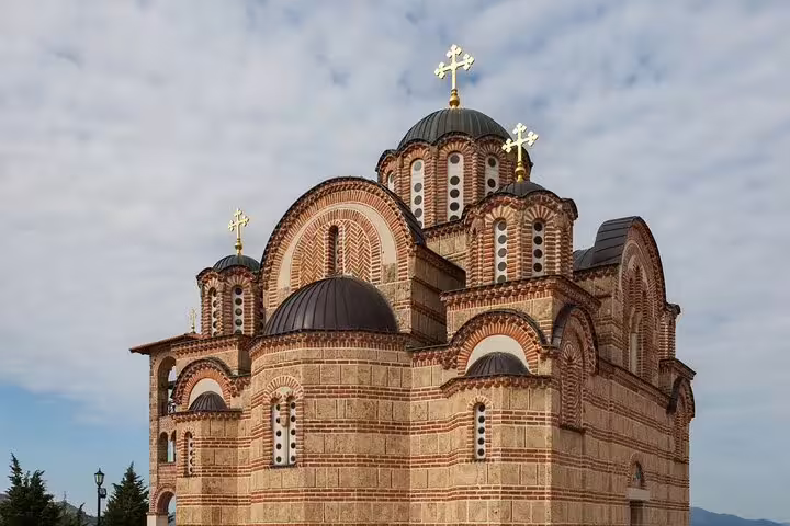 Orthodox monastery church with domes and crosses, cultural highlight on Trebinje private car tour in Herzegovina