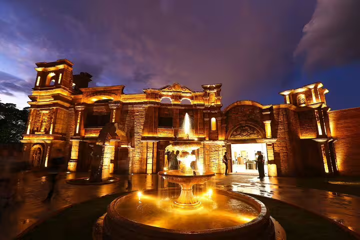 Illuminated historic facade and fountain at Tres Fronteiras landmark during an evening private guided tour.
