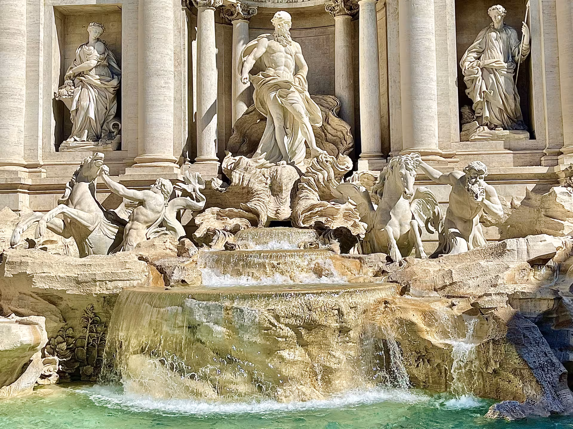 Close-up of Trevi Fountain statues and turquoise water featured on a Civitavecchia to Rome VIP golf cart tour with Colosseum