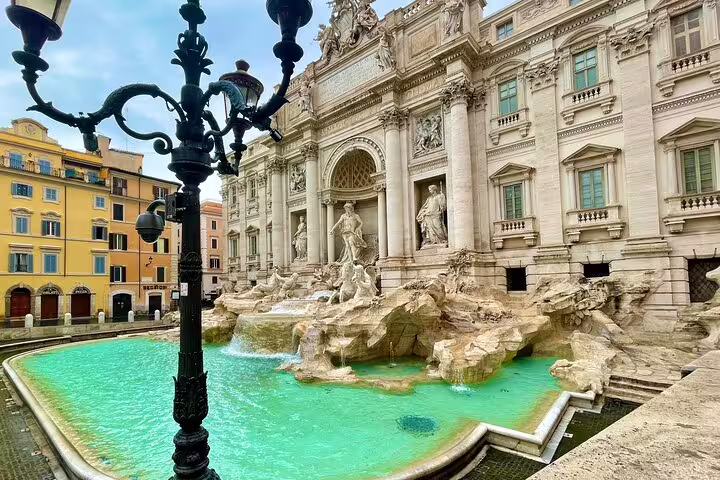 Tourists visit the Trevi Fountain’s turquoise pool and baroque façade on a Best of Rome Colosseum, squares and fountains walk